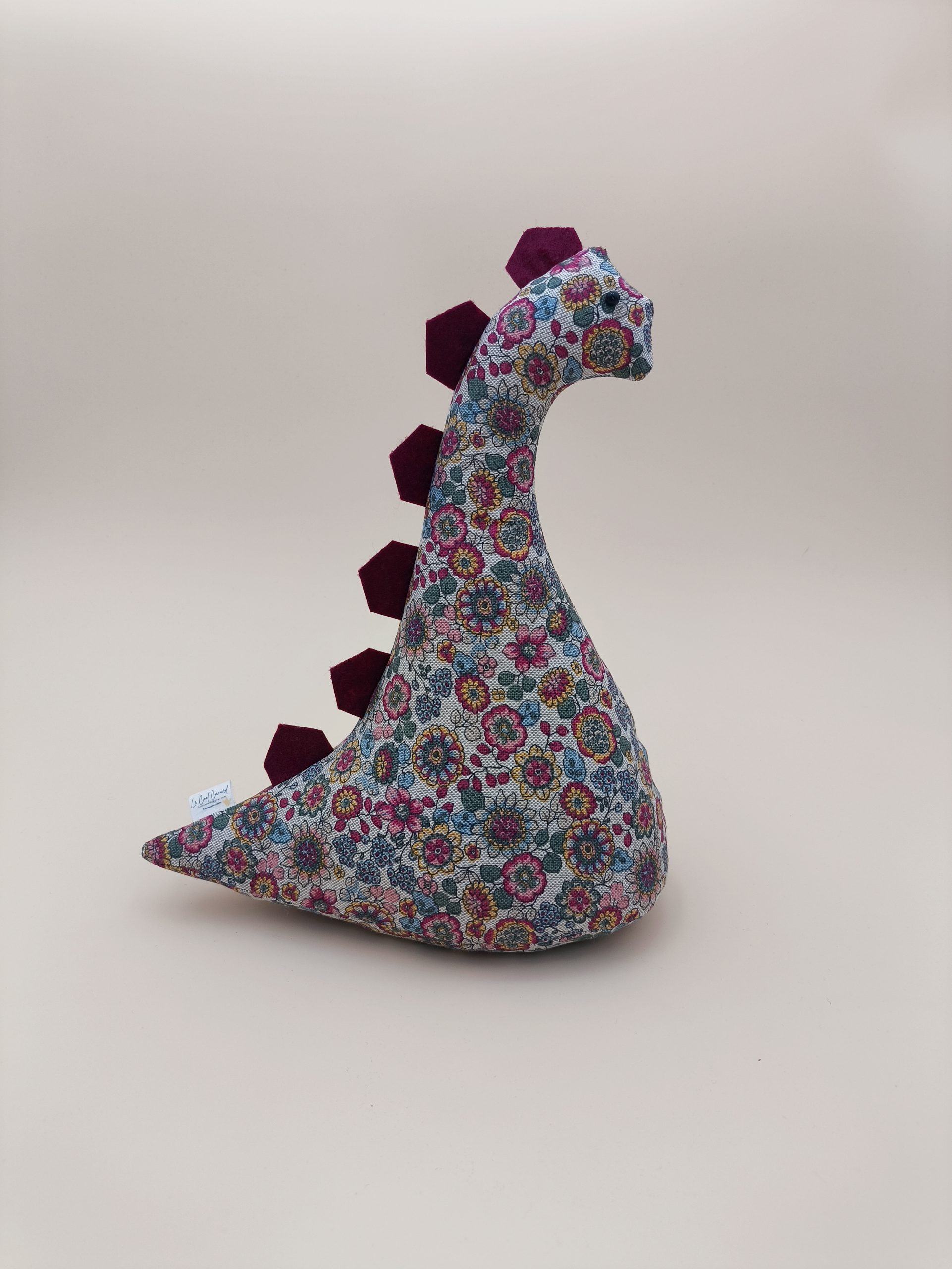 Cale-porte dinosaure - fleurs bordeaux, rose, bleu et jaune sur fond lin