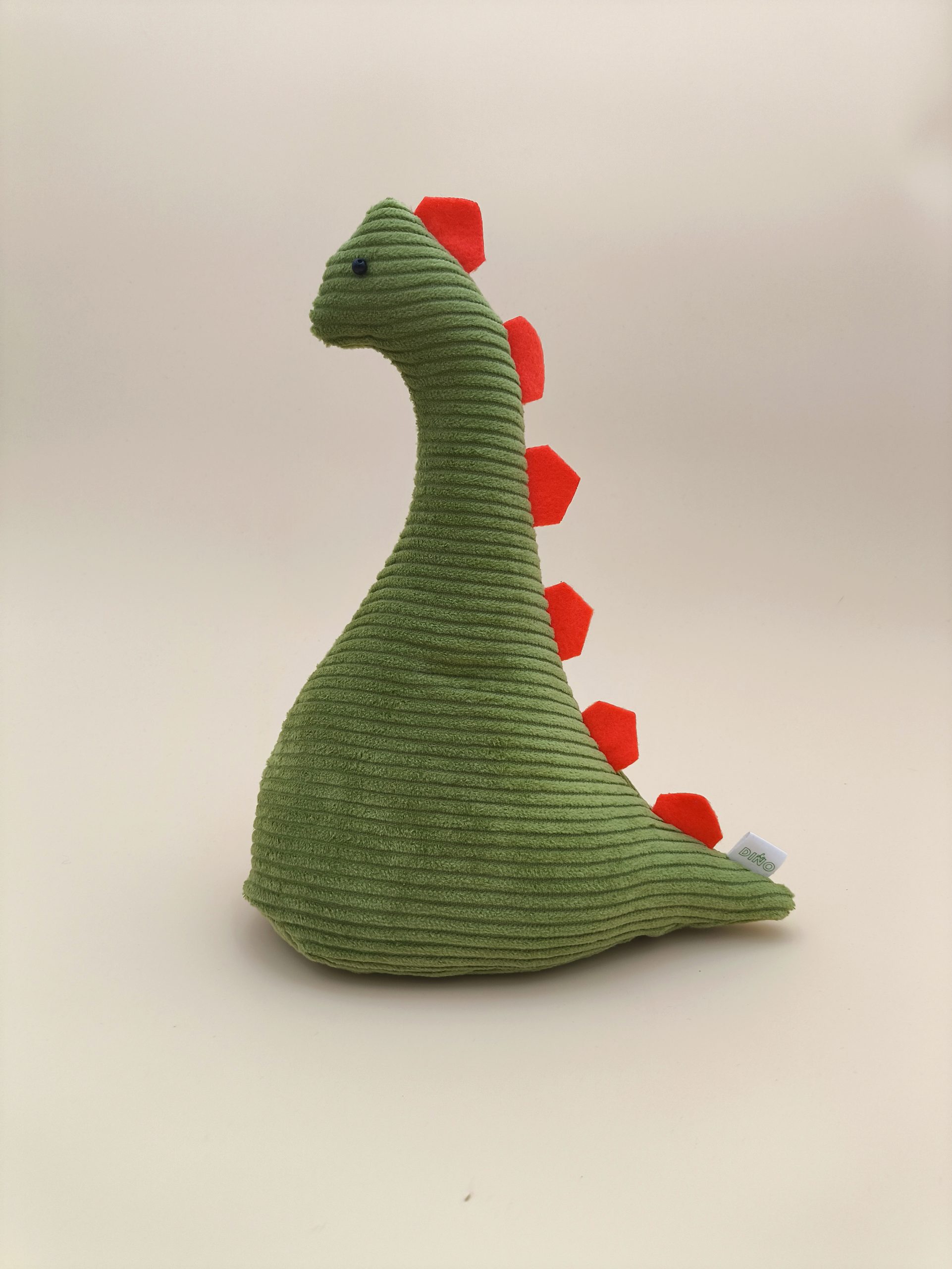 Cale-porte dinosaure - velours cotelé vert avec ses plaques orange